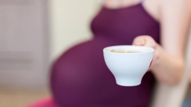 Is caffeine safe while pregnant? Here's the research around drinking coffee while pregnant, a midwife's opinion, and what other natural moms are doing.