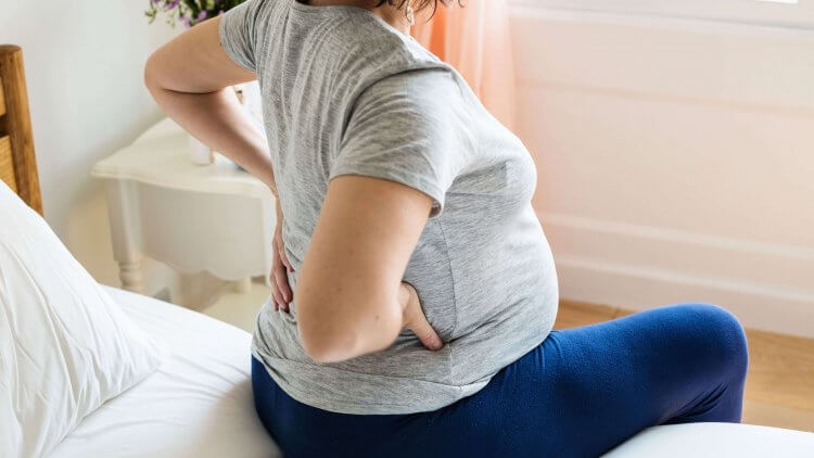 Back Pain in Pregnancy: When It Starts, Causes, How to Get Relief